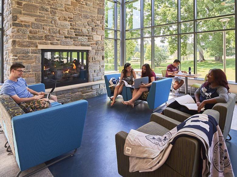 Students sitting by the fire in the Fireside Lounge